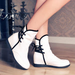 Stylish round-toe panels with solid color ties inside the heightened ladies booties